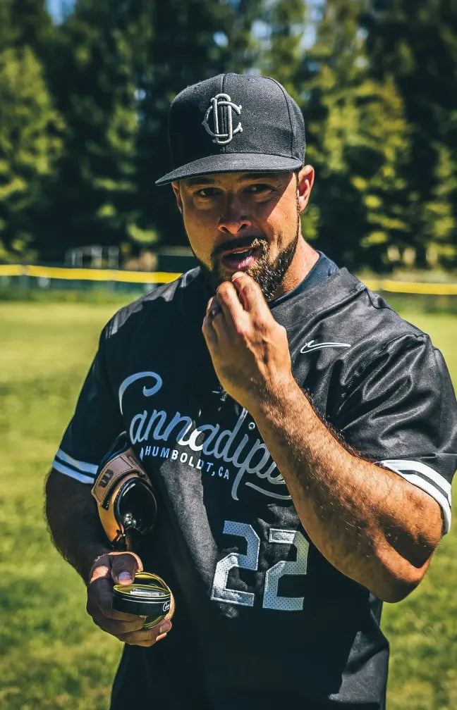 Ball player in a Cannadips jersey putting in a pouch
